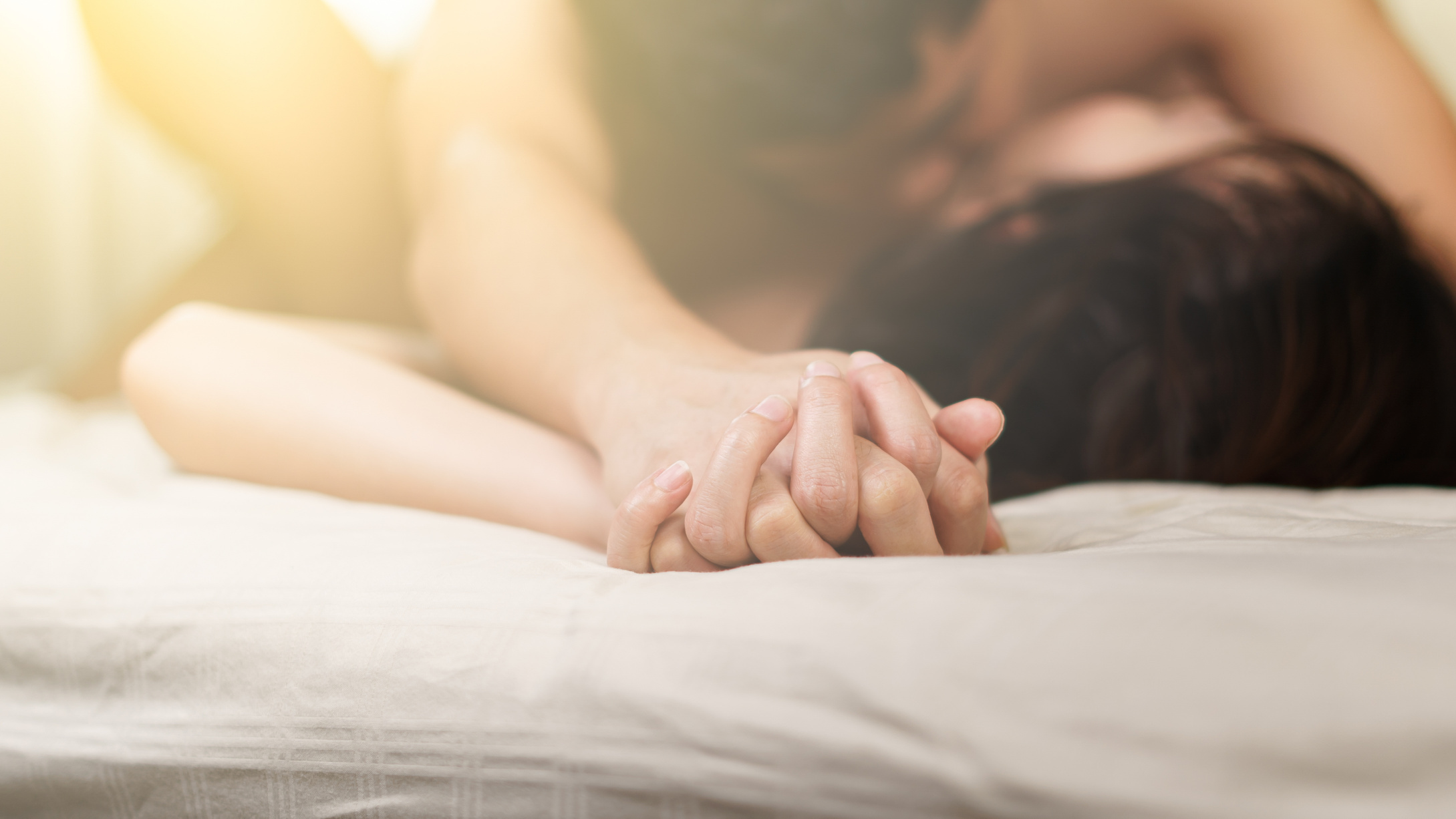 Hand Grasping and Making Love in Bed